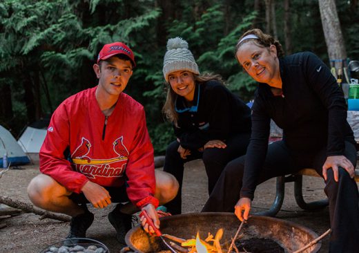 Kayakers hanging out by the campfire